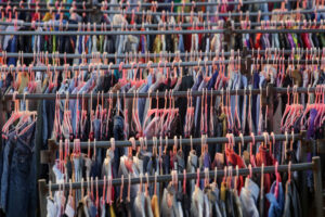 clothes hanging on hangers in warehouse