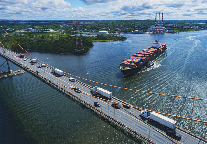 container ship below bridge