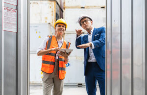 foreman and employee looking in container box