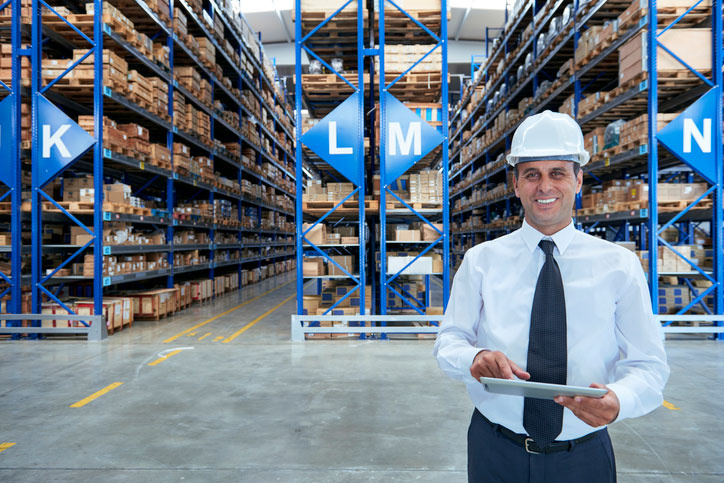 manager using tablet in warehouse