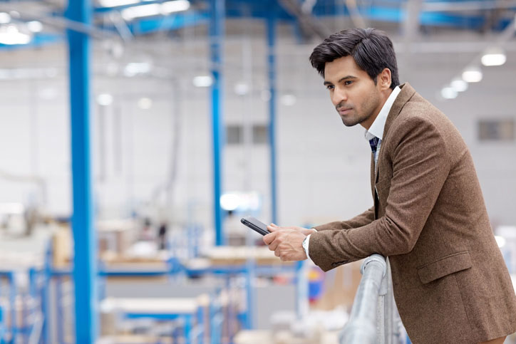 manager looking from warehouse balcony