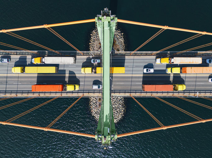 semi trucks crossing bridge