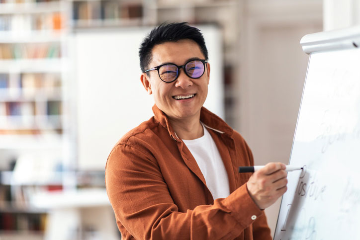 smiling teacher at whiteboard