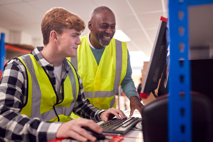 supervisor training employee on computer