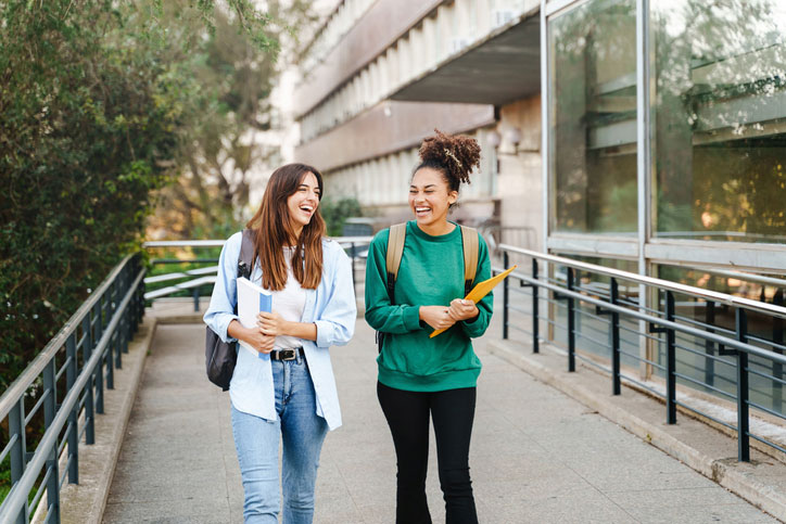 two students walking and laughing at school