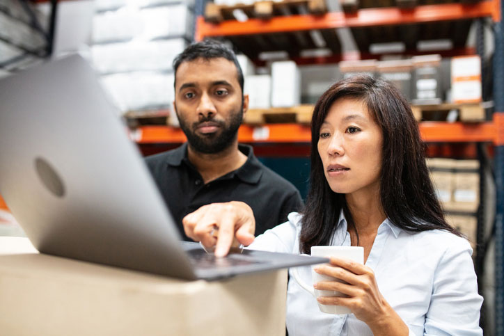 warehouse staff working on laptop