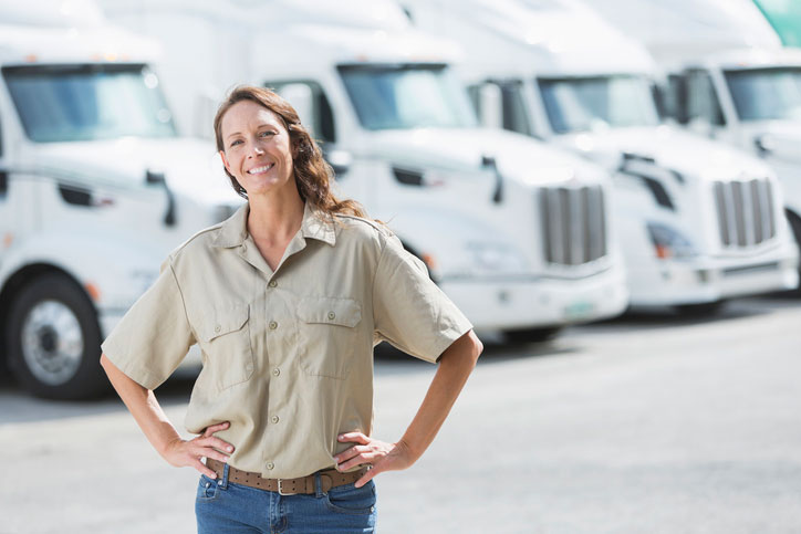 woman in front of semi trucks at distribution center