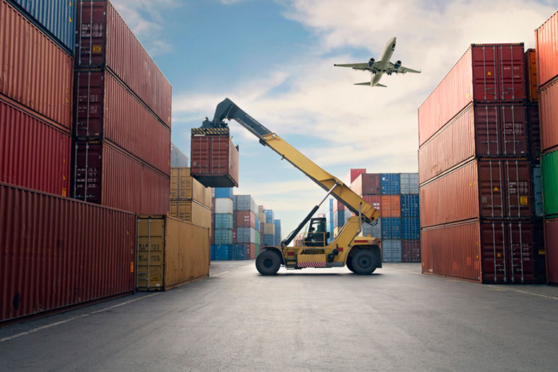 container port with airplane above