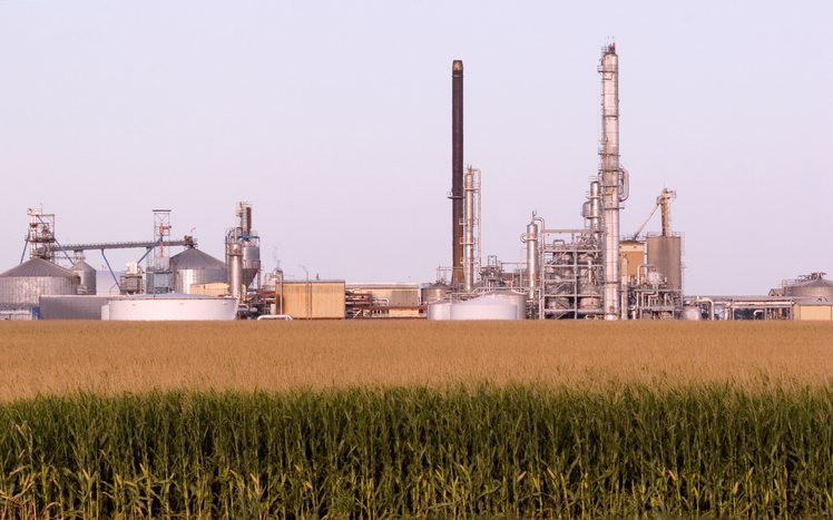 nebraska corn field with ethanol plant in background