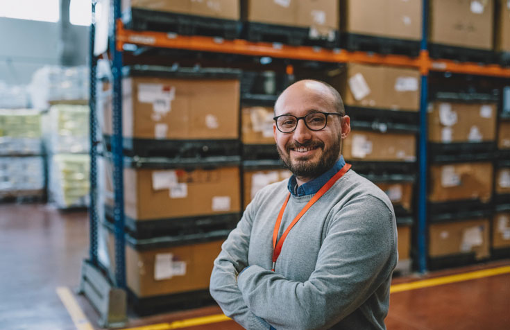 smiling logistics manager in warehouse