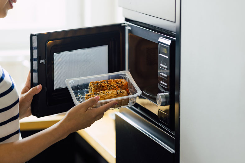woman using microwave