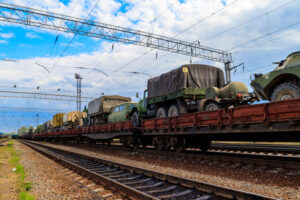 cargo train carrying military vehicles