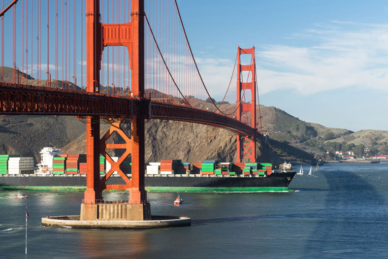 container ship in san francisco, california, under golden gate bridge