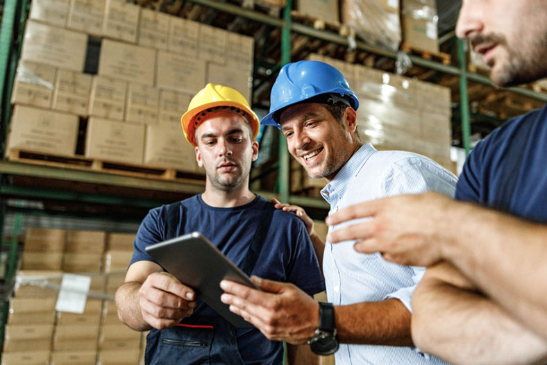 logistics manager and crew in warehouse