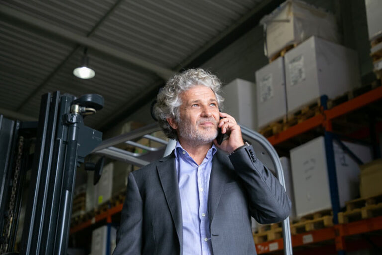 on the phone in the warehouse