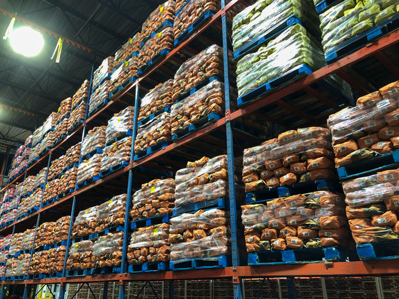 pallets of potato sacks in a warehouse