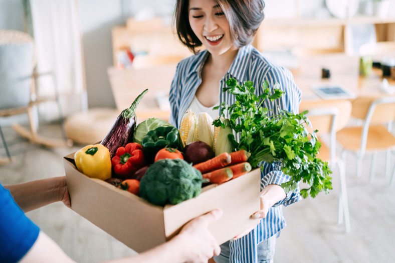 receiving box of fresh vegetables