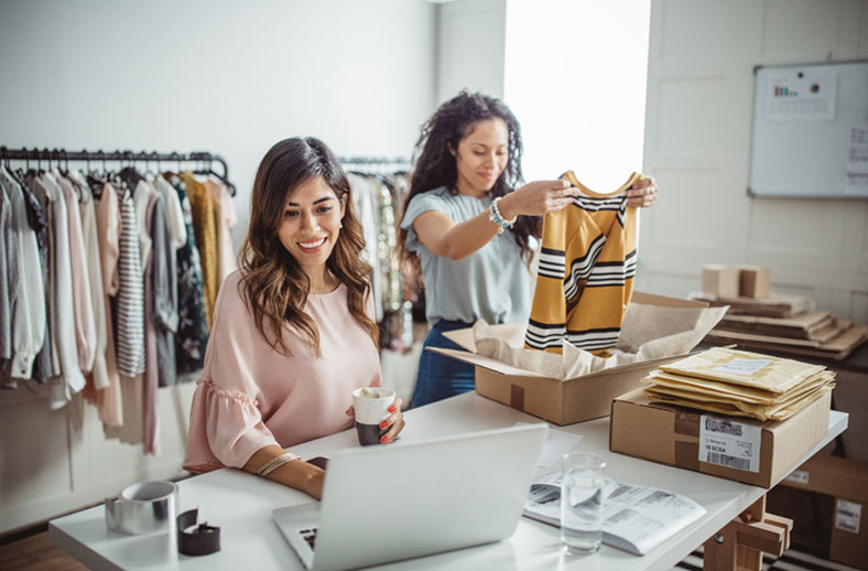 small business owners folding clothes