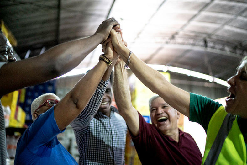 happy group of employees in warehouse